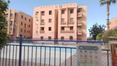 a building with a fence in front of a building at Casa Rosa in Marrakech