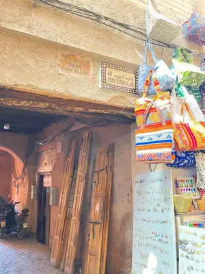 a building with wooden doors and bags on the wall at Riad Elegant suite in the heart of the Medina in Marrakech