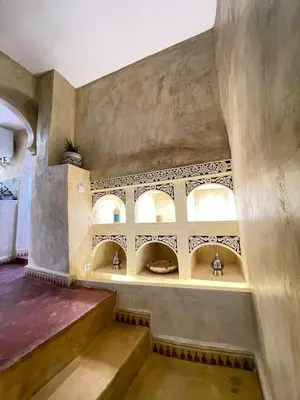 a room with a staircase and a wall with windows at Riad Elegant suite in the heart of the Medina in Marrakech