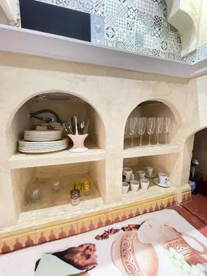 a doll house with plates and dishes on a shelf at Riad Elegant suite in the heart of the Medina in Marrakech