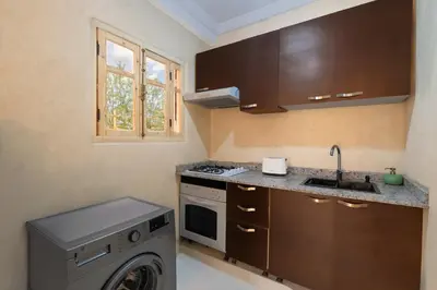 a kitchen with a washing machine and a sink at Modern studio with terrace in Marrakech