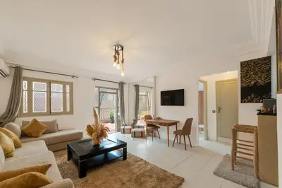 a living room with a couch and a table at Modern studio with terrace in Marrakech