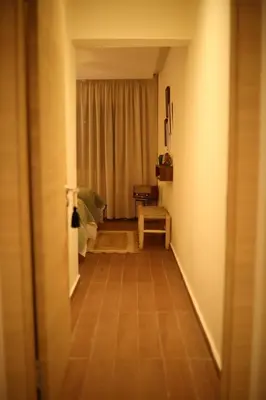 a hallway with a room with a table and a window at Casaterra Luxury apartment with pool & home-cinema in Marrakech
