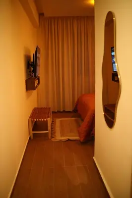 a room with a bed and a mirror on the wall at Casaterra Luxury apartment with pool & home-cinema in Marrakech