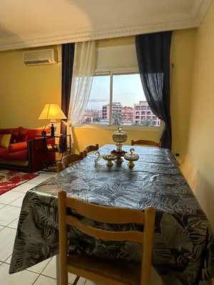 a dining room table with a view of a city at Appartement, centre-ville, Marrakech, Gueliz in Marrakech