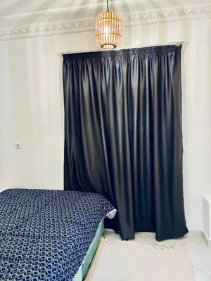a bedroom with a bed and a black curtain at the sweet night of Marrakech in Marrakech