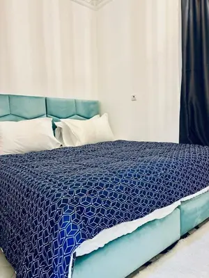 a bedroom with a blue bed with a blue comforter at the sweet night of Marrakech in Marrakech