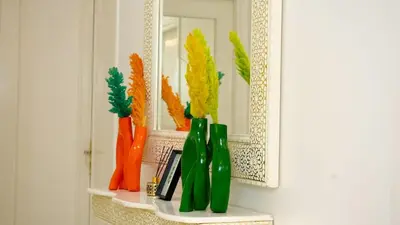 a shelf with a mirror and green bottles on it at the sweet night of Marrakech in Marrakech
