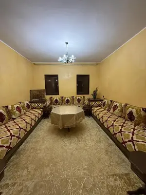 a large living room with couches and a table at Location longue durée in Marrakech
