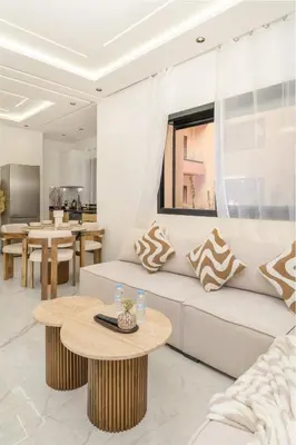 a living room with a couch and a table at Dar élégant au centre de Marrakech piscine in Marrakech
