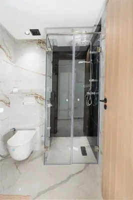 a glass shower in a bathroom with a toilet at Dar élégant au centre de Marrakech piscine in Marrakech