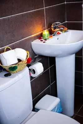 a bathroom with a white sink and a toilet at Appartement traditionnel au médina in Marrakech