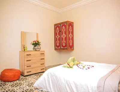 a bedroom with a bed and a dresser and a mirror at Appartement traditionnel au médina in Marrakech