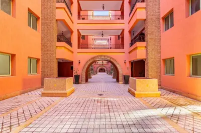 an empty hallway of a building with an archway at Suite Moderne Deluxe Miracle, à Babylone, Hyper-Centre, Marrakesh in Marrakech