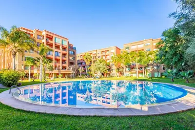 a large swimming pool in front of a building at Suite Moderne Deluxe Miracle, à Babylone, Hyper-Centre, Marrakesh in Marrakech
