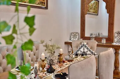 a dining room with a table with candles and chairs at Dar Kech Luxury et comfort in Marrakech
