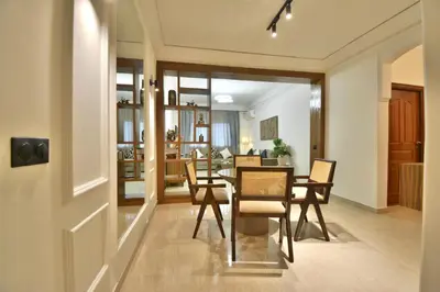 a dining room and living room with a table and chairs at L'adresse- Appartement 4p au centre de Marrakech in Marrakech