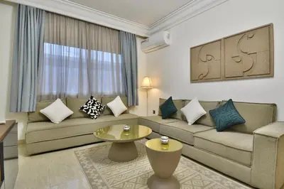 a living room with a couch and a table at L'adresse- Appartement 4p au centre de Marrakech in Marrakech