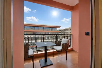 a balcony with a table and chairs at L'adresse- Appartement 4p au centre de Marrakech in Marrakech