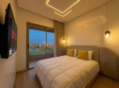 a bedroom with a large bed and a large window at Modern, Luxurious, Pool View, 3 Terraces, Golf in Marrakech