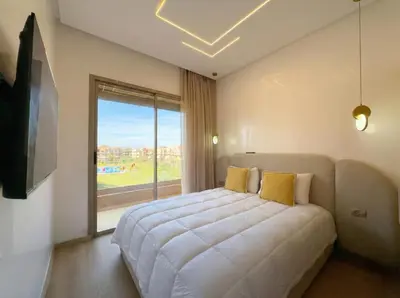 a bedroom with a large bed and a large window at Modern, Luxurious, Pool View, 3 Terraces, Golf in Marrakech