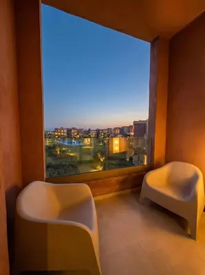 a room with two chairs and a large window at Modern, Luxurious, Pool View, 3 Terraces, Golf in Marrakech