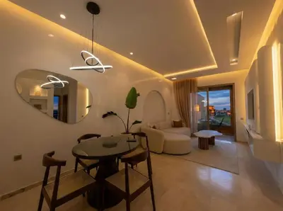 a living room with a table and a mirror at Modern, Luxurious, Pool View, 3 Terraces, Golf in Marrakech