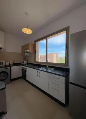 a kitchen with a sink and a large window at Modern, Luxurious, Pool View, 3 Terraces, Golf in Marrakech