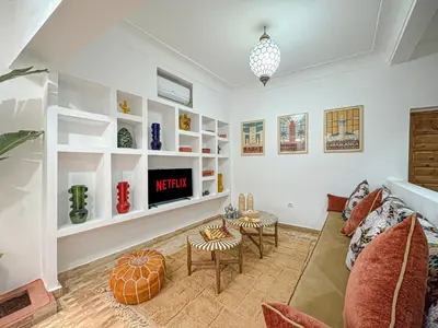 a living room with a couch and a table at Riad Louzaia, Marrakech in Marrakech