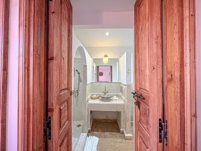 a hallway with a bathroom with a sink at Riad Louzaia, Marrakech in Marrakech