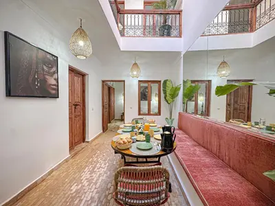 a dining room with a table with food on it at Riad Louzaia, Marrakech in Marrakech