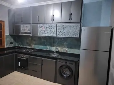 a kitchen with a refrigerator and a washing machine at house mohamed in Marrakech