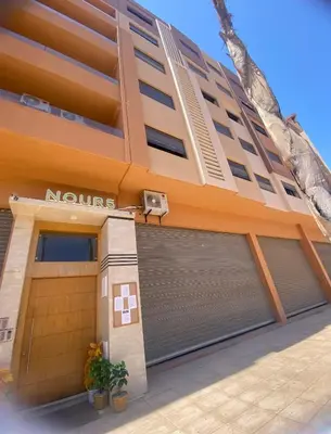 a building with two garage doors in front of it at Appartement 2 chambres à Gueliz avec piscine Emplacement parfait in Marrakech