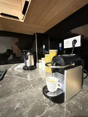 a cup of coffee is coming out of a toaster at flat in Marrakech in Marrakech