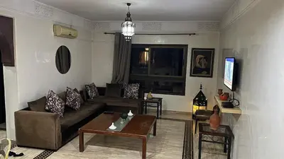 a living room with a couch and a table at Secure luxury apartment in Marrakech