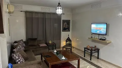 a living room with a couch and a table at Secure luxury apartment in Marrakech