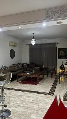 a living room with a couch and a table at Secure luxury apartment in Marrakech