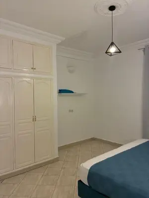 a bedroom with a bed and a white cabinet at the wonder of Marrakesh in Marrakech