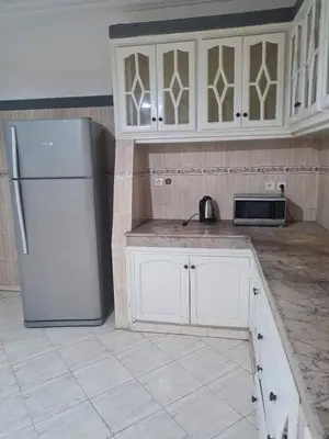 a kitchen with white cabinets and a refrigerator at the wonder of Marrakesh in Marrakech