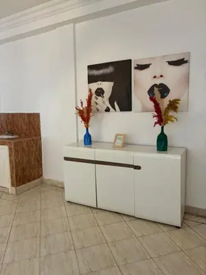 a white cabinet with two vases on it in a room at the wonder of Marrakesh in Marrakech