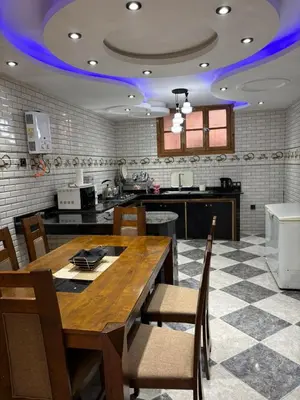 a kitchen with a large wooden table and chairs at Un appartement au rez-de-chaussée dans une maison in Marrakech