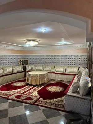 a living room with a couch and a table at Un appartement au rez-de-chaussée dans une maison in Marrakech