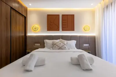 a bedroom with a large white bed with two pillows at palace studio gueliz et proche gare central in Marrakech
