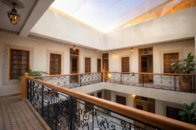 an indoor balcony of a building with a skylight at Riad el fassi & spa charme authentique piscine chauffée in Marrakech