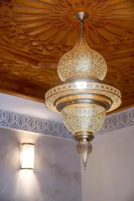 a large chandelier hanging from a ceiling at Riad el fassi & spa charme authentique piscine chauffée in Marrakech