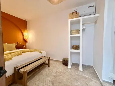 a bedroom with a bed and a book shelf at Kasbahbibi pool breakfast city center private in Marrakech
