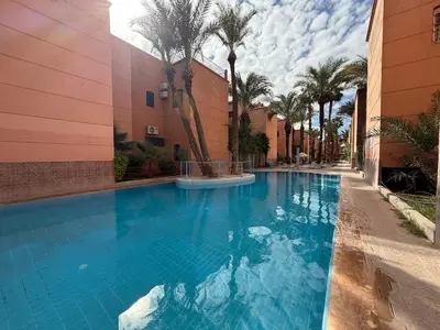 a large blue swimming pool next to a building at Calm & Authentic in Marrakesh in Marrakech