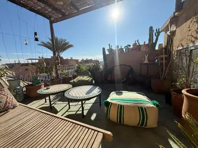 a patio with two tables and chairs and cactuses at Calm & Authentic in Marrakesh in Marrakech
