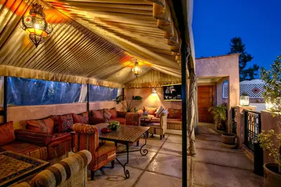a patio with a couch and a table on a patio at Riad Matins De Marrakech in Marrakech