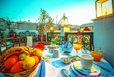 a table with a basket of fruit on a patio at Riad Matins De Marrakech in Marrakech